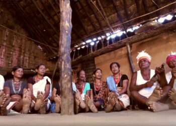 Nuapada tribals in traditional dresses and headgear adorned with feathers sing and play musical instruments to celebrate a Saora marriage | The Indian Tribal
