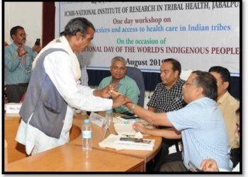 A Tribal Healer (Gunia) Performing Naadi Parikshan Of A Medical Scientist